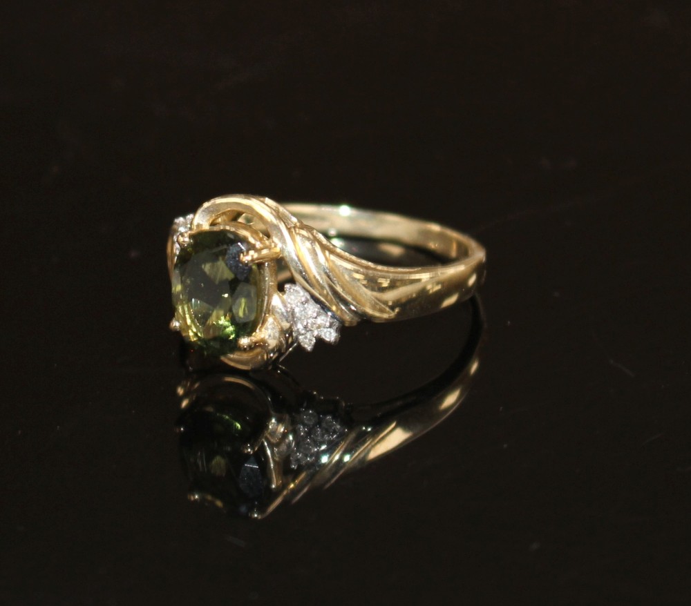 A modern 9ct gold, olive green paste and diamond set dress ring, size S, gross weight 3.2 grams.